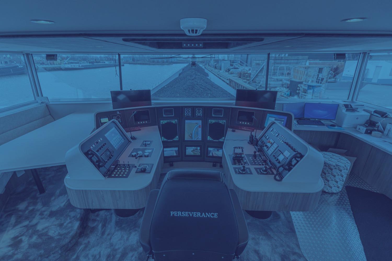 Connected electronic and navigation systems in the wheelhouse of a modern inland vessel.
